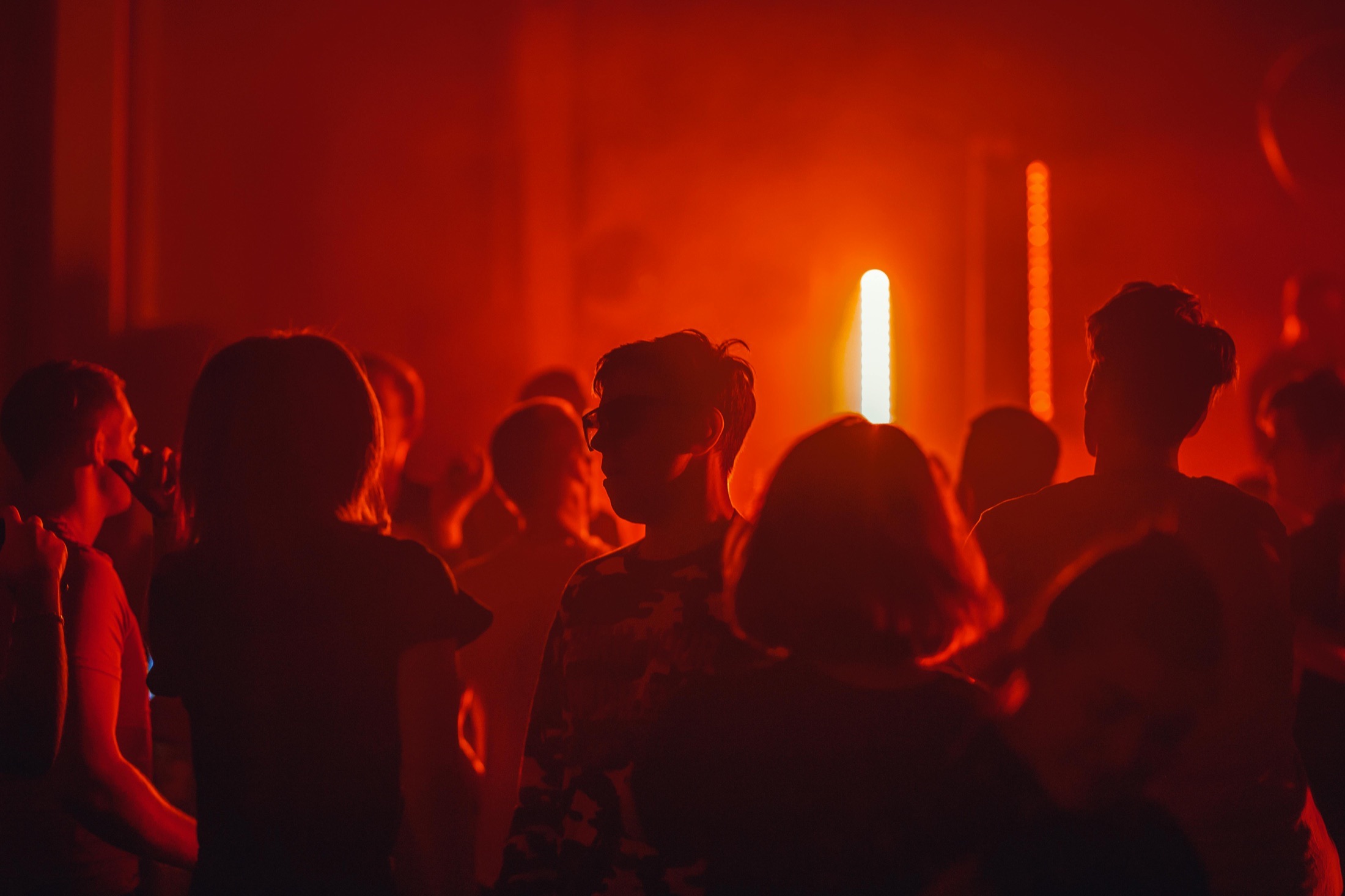 Guests gathered under red celebration lights
